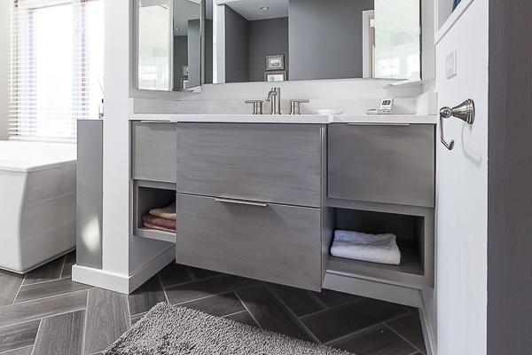 Floating vanity shows floor tiles below
